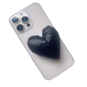 Puffy black heart fabric phone stand with magnetic base on light purple smartphone