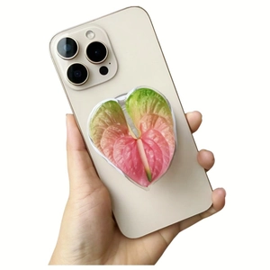 Detail of heart-shaped acrylic phone grip featuring a pink floral gradient on a mobile phone