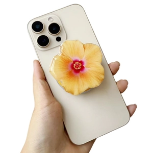 Close-up of yellow flower acrylic phone socket grip held on white smartphone