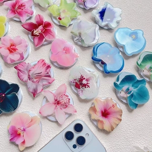 Detail of orchid and lily shaped magnetic acrylic phone grips in various pastel colors