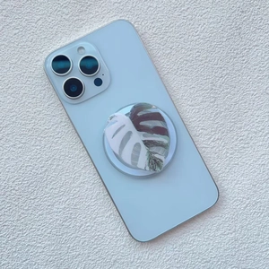 Close-up of Monstera leaf pattern on magnetic phone grip stand attached to mobile device