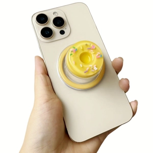 Detail of yellow donut pop socket with colorful sprinkles on a cream smartphone