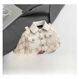 Detailed close-up of cream PU leather jacket-shaped mini bag with brown floral patterns