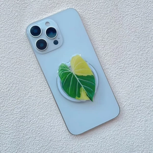Detailed close-up of a variegated leaf phone grip showing realistic plant texture and gloss