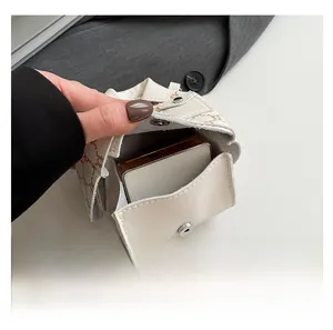 Detail view showing the magnetic flap closure and compact interior of the crossbody bag