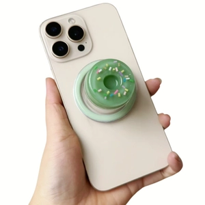 Creative 3D green donut phone socket stand held on a smartphone for secure grip