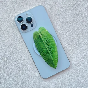 Macro detail of leaf-shaped phone grip with realistic vein texture on a blue smartphone
