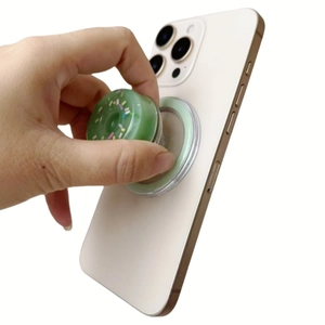 Magnetic donut phone socket grip on smartphone showing retractable airbag function