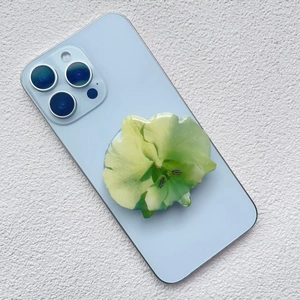 Macro detail of orchid shaped acrylic phone socket with translucent light green petals
