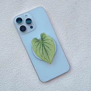 Detailed view of leaf shaped phone grip with realistic vein textures on a smartphone