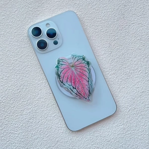 Macro detail of leaf-shaped magnetic phone grip with pink and green botanical textures