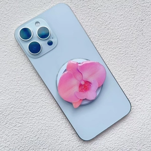 Macro detail of orchid acrylic phone grip with realistic pink floral petal texture