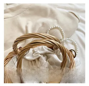 Detail of hand-woven straw bag featuring delicate lace trim and cotton drawstring lining