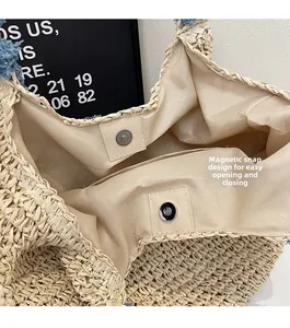 Detail of straw tote bag interior with magnetic metal clasp and light fabric lining