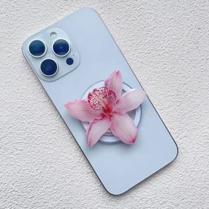 Close-up of a pink gradient orchid phone grip on a light blue smartphone case