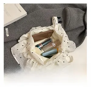 Top view of white floral tote bag interior showing large capacity for cosmetics and phone