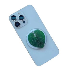 Universal magnetic acrylic phone grip featuring a realistic green leaf design on white base