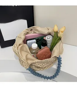 Top view of straw tote bag interior showing large capacity with personal essentials