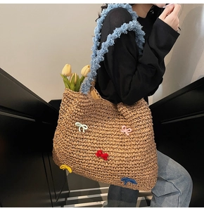 Detail of straw tote bag with colorful bows and blue fuzzy shoulder strap texture