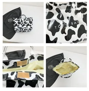 Détails du sac cabas imprimé vache avec velcro, poche interne et finition brillante