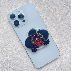 Close-up of orchid acrylic magnetic phone stand with blue petals on a blue smartphone