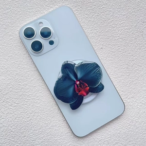 Detail of dark blue orchid acrylic magnetic phone socket mounted on a light blue phone