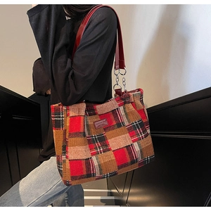 Detailed close-up of retro plaid tote bag featuring red leather handles and silver chains