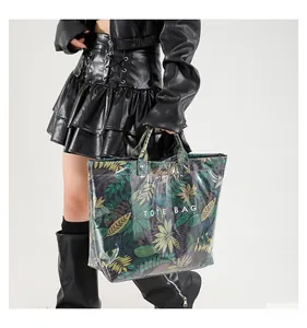Détail d'un grand sac cabas avec un imprimé vibrant de feuilles tropicales vertes