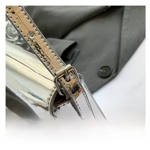 Detailed macro of the silver metallic shoulder strap with an adjustable metal pin buckle