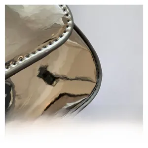 Detailed macro view of the glossy silver patent leather texture and fine edge stitching