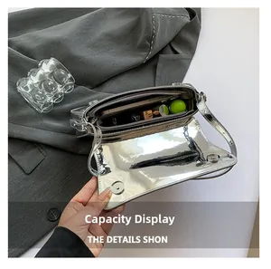 Top view of open silver metallic shoulder bag showing interior capacity for essentials