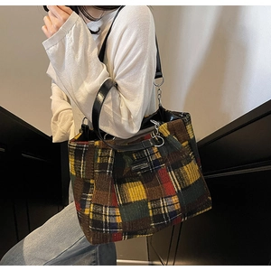 Detail of multi-color plaid tweed tote bag with leather and silver chain handles