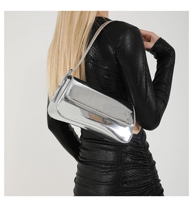 Close-up of metallic silver mirror finish underarm bag with minimalist slim shoulder strap