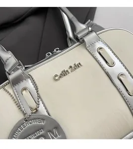 Detailed close-up of the silver and beige leather texture with crocodile embossing