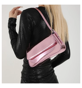 Macro side view of metallic pink patent leather shoulder bag with glossy finish