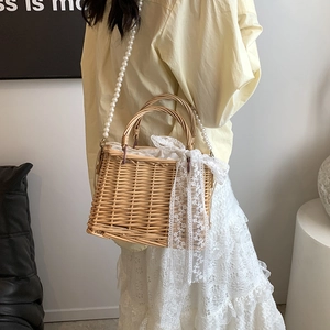 Retro straw basket bag with pearl strap and white lace bow for casual summer beach styling
