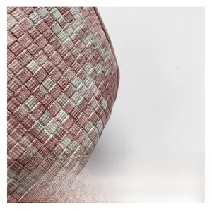 Detailed macro view of high-quality woven texture in light pink and cream white fabric