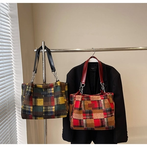 Detail of plaid tote bags with leather chain straps and stylish check pattern
