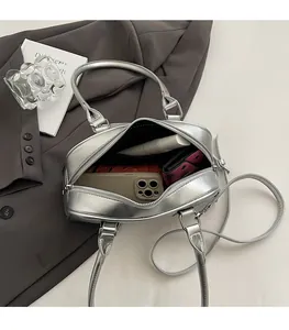 Interior view showing the large capacity of a silver metallic boston bag with essentials