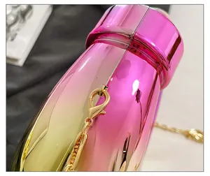 Close-up of premium gold metal clasp and chain on pink gradient acrylic evening bag