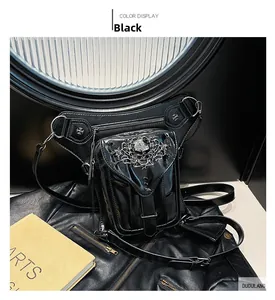Detail of a black patent leather steampunk leg bag with silver skull buckle and straps