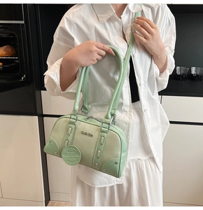 Detailed view of mint green bowling bag with gradient wood texture and silver hardware