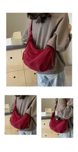 Detailed close-up of dark red canvas dumpling bag with thick rope woven zipper puller