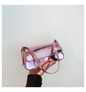 Detail of pink metallic patent leather bag with white contrast stitching and slim strap