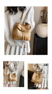Detail of woven straw bucket bag featuring brown leather trim and drawstring closure