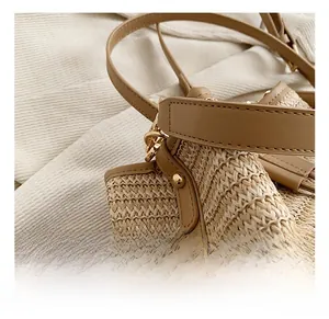 Close-up of premium gold hardware and fine straw weave on the beach bucket bag