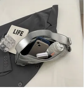 Top view showing the large interior capacity of a silver metallic baguette shoulder bag