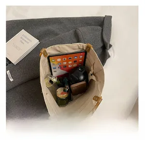 Interior view showing large storage capacity of the woven tote bag with daily essentials