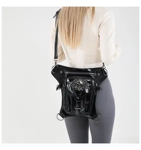 Steampunk black thigh bag with metallic skull and cross rivets shown on a model