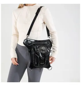 Detail of black steampunk leg bag with silver skull ornament and adjustable straps